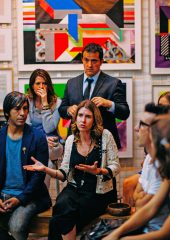 A group of people listening to someone talking