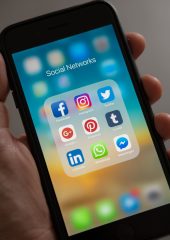 A phone showing different social media apps.