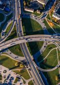 An aerial view of a roundabout with lots of other roads linking into it.